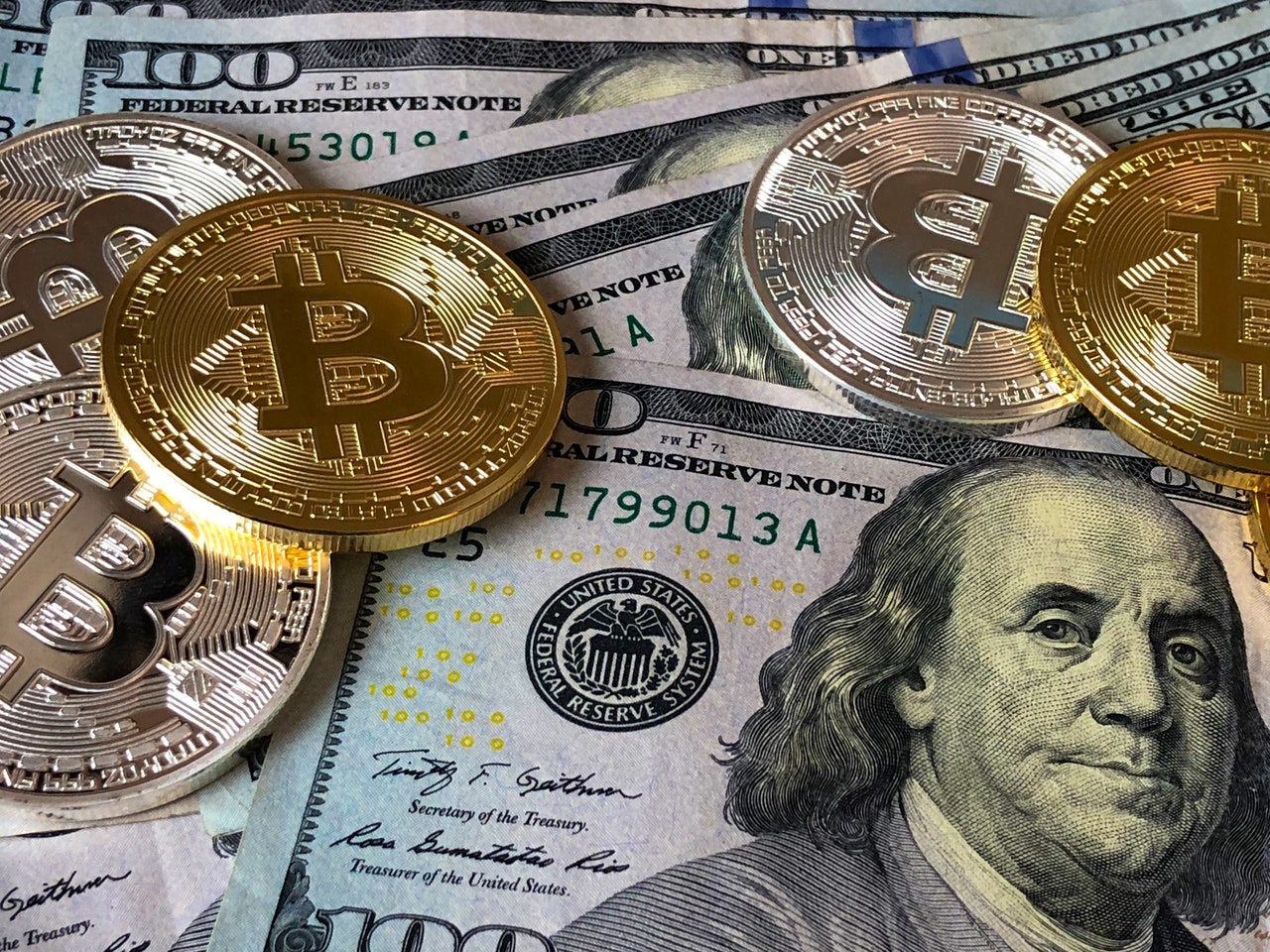 bitcoins-and-u-s-dollar-bills-730547-2